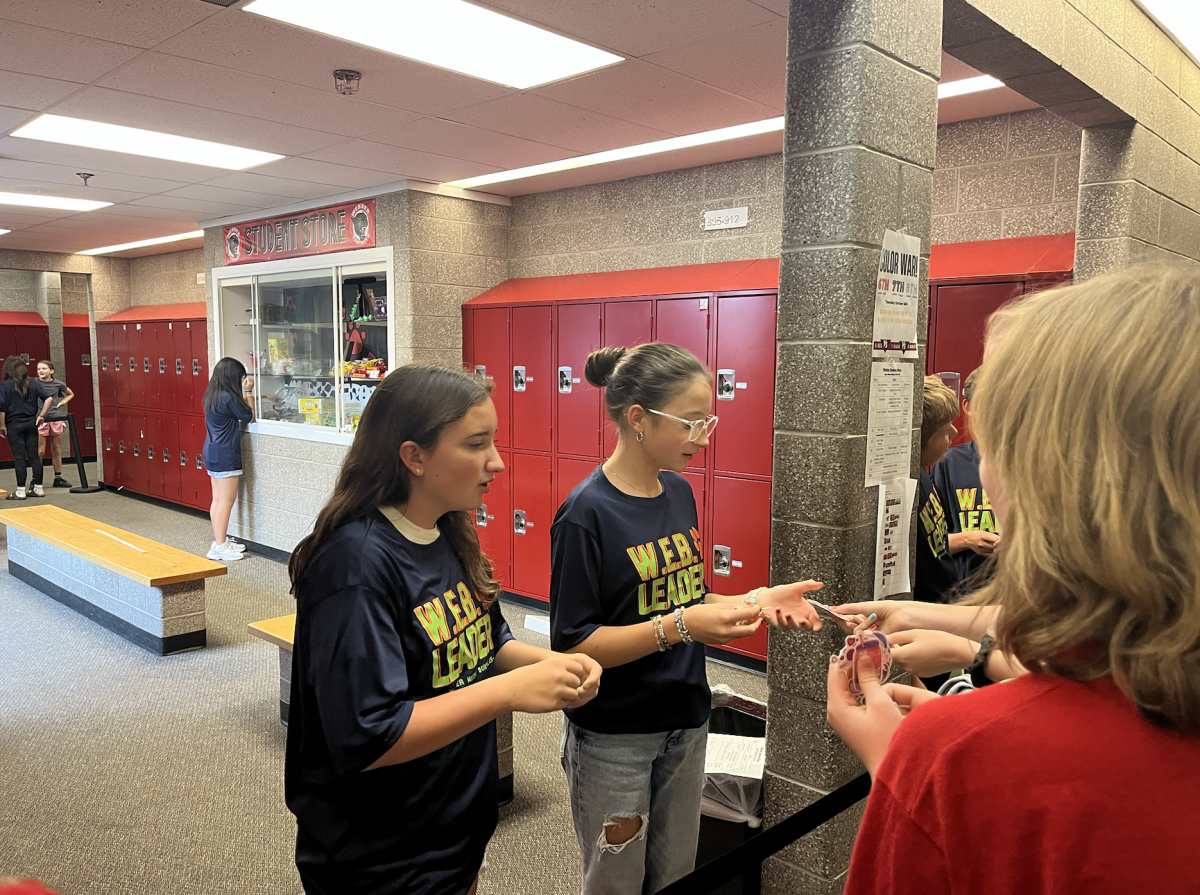 Two WEB Leaders talk with students at the student store on a Wednesday afternoon. 